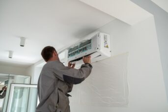 Technician repairing AC